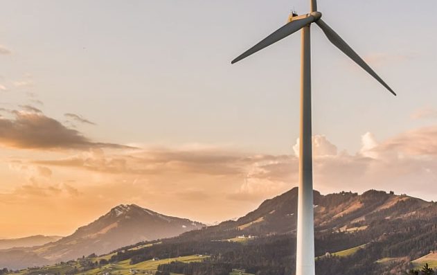 Windmill on grassy field