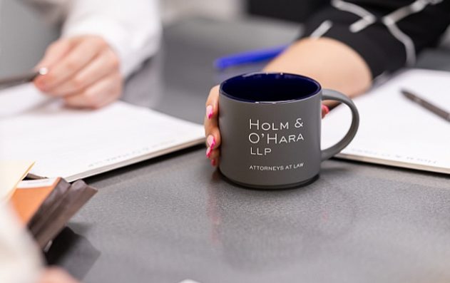 Holm & O'Hara LLP coffee mug on table