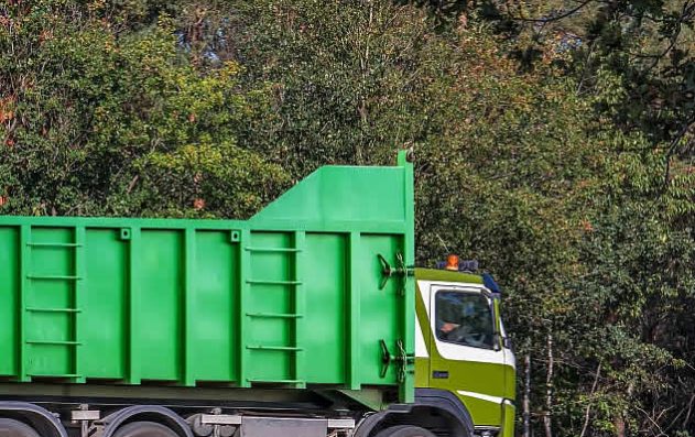 Green Recycling Truck moving down road